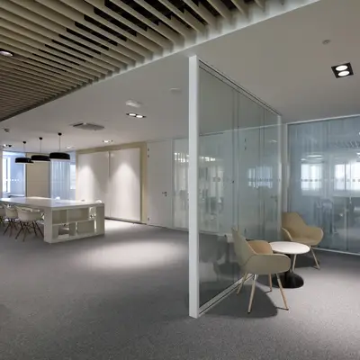 Glass partitions divide the space and also allow natural light to flood the entire space